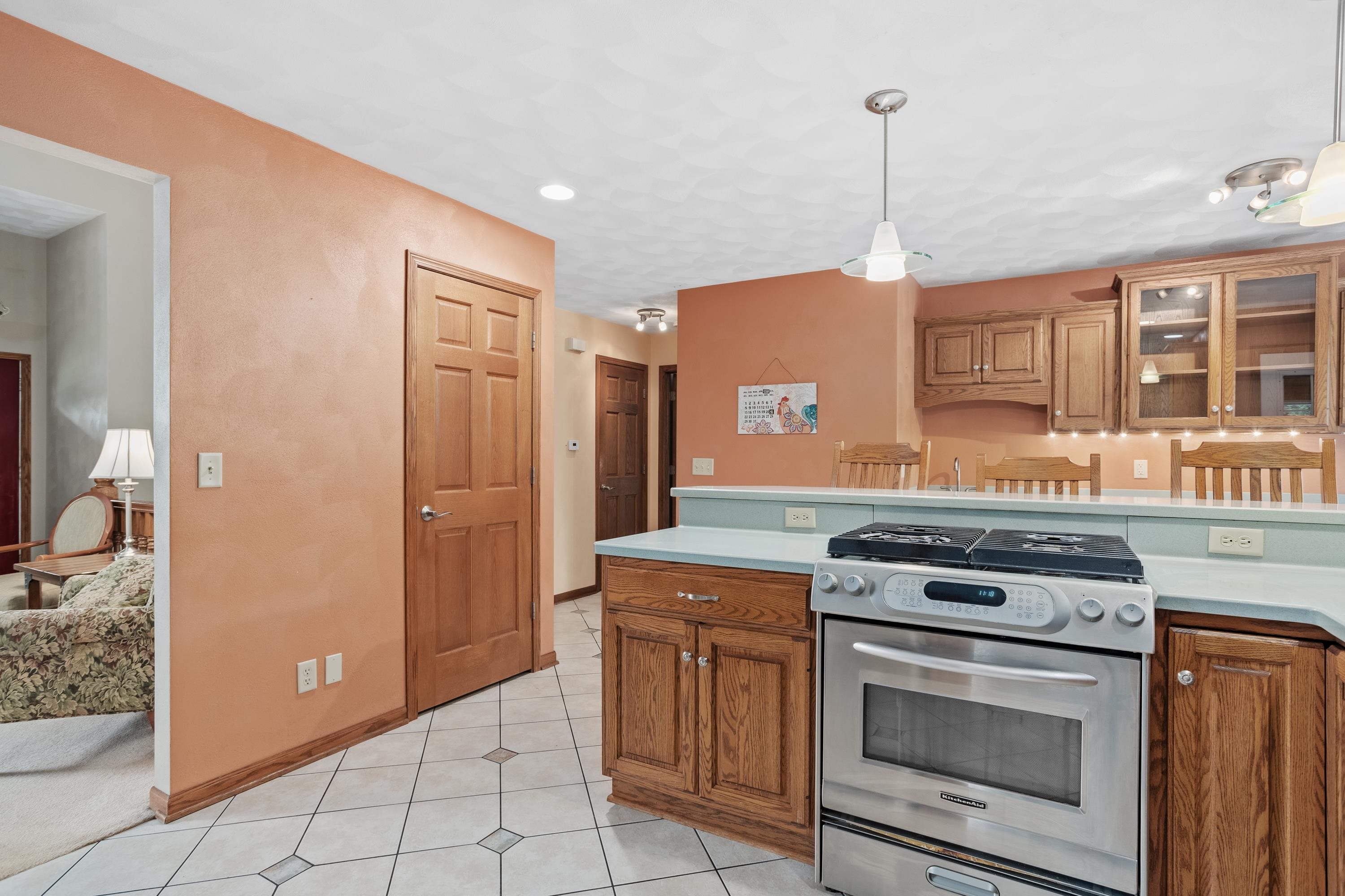 13294 Weatherfield Way Roscoe, IL 61073 - Photo 20 of 38 a kitchen with stainless steel appliances granite countertop a stove and a refrigerator