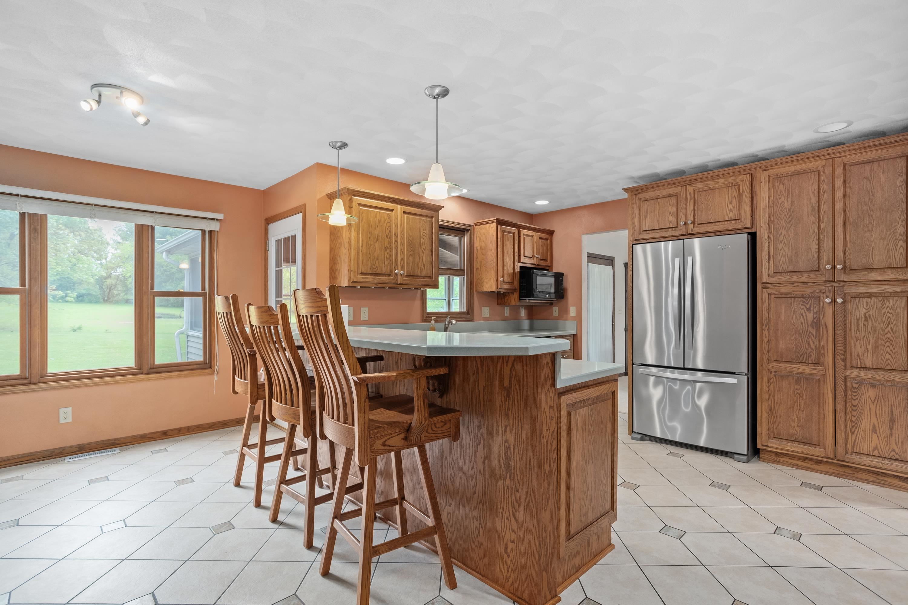 13294 Weatherfield Way Roscoe, IL 61073 - Photo 21 of 38 a kitchen with refrigerator a table and chairs