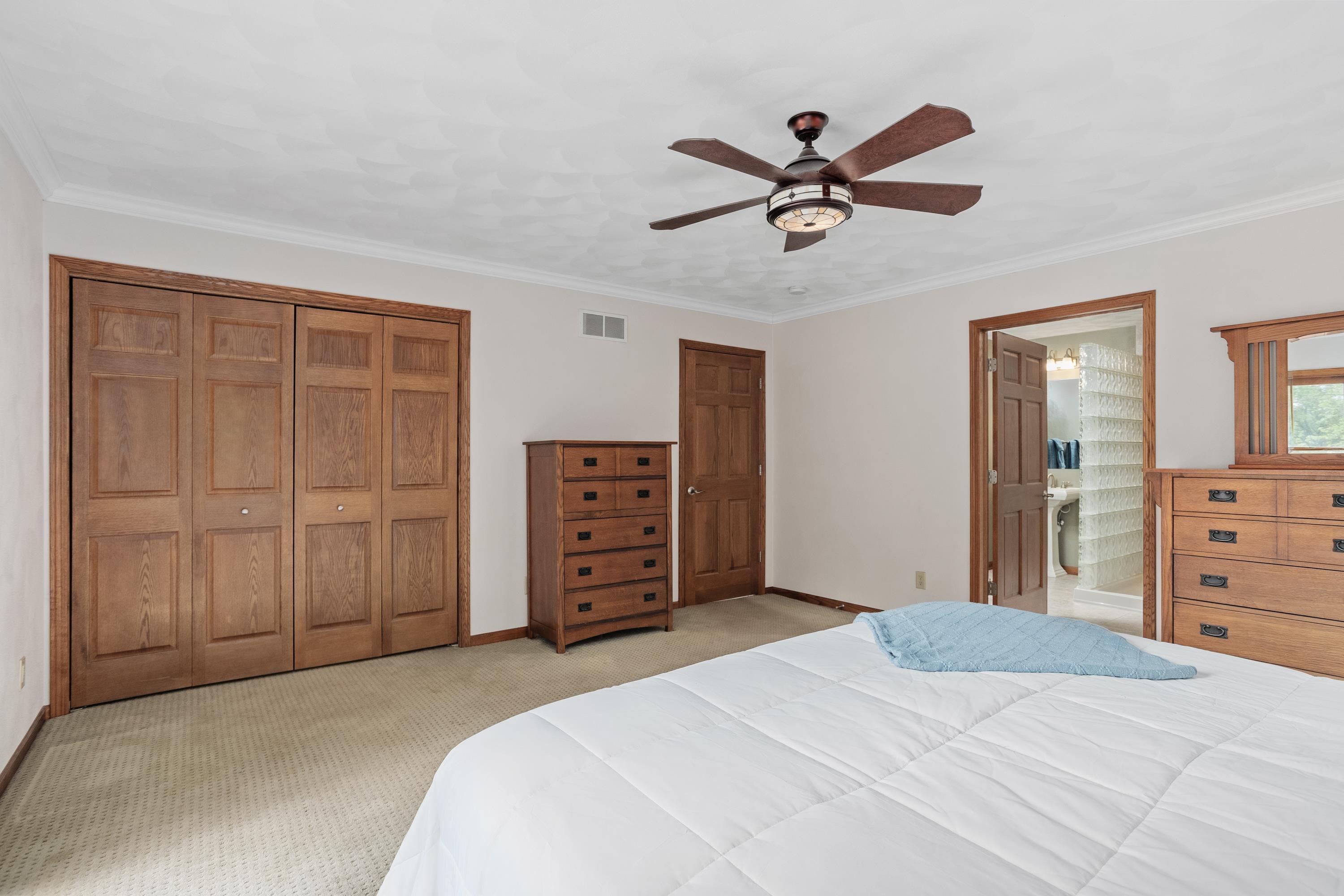 13294 Weatherfield Way Roscoe, IL 61073 - Photo 28 of 38 a bedroom with a bed and a chandelier