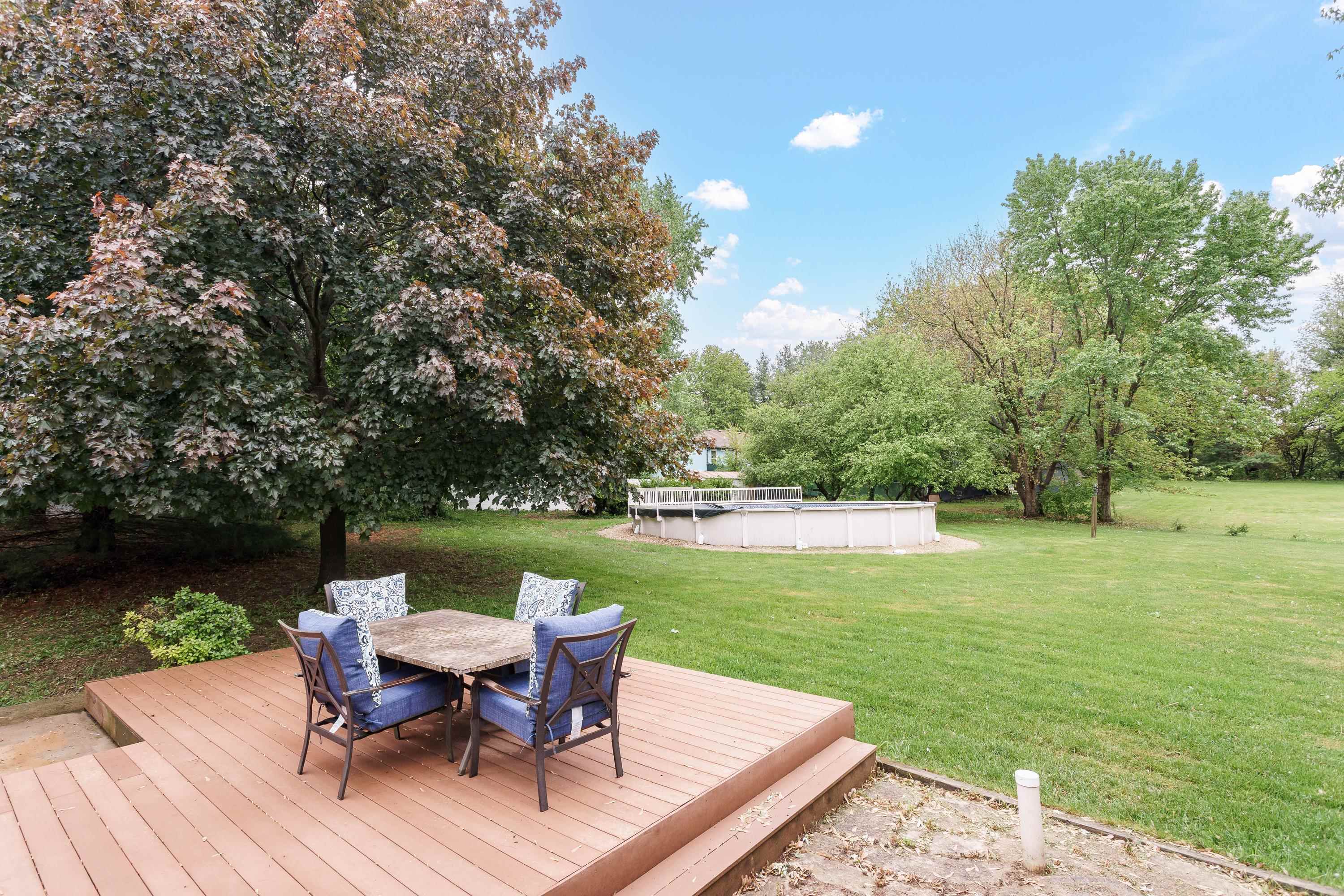 13294 Weatherfield Way Roscoe, IL 61073 - Photo 3 of 38 a table and chairs sitting in the middle of a lake