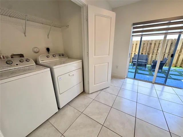 a large kitchen with a stove a refrigerator and a sink