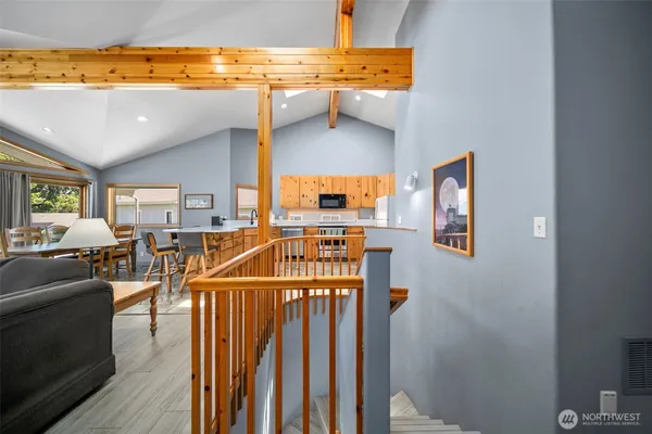 a view of a livingroom with furniture wooden floor and windows