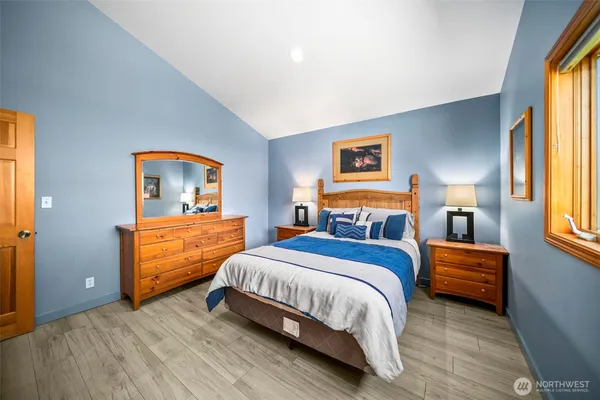 a bedroom with a bed and a dresser