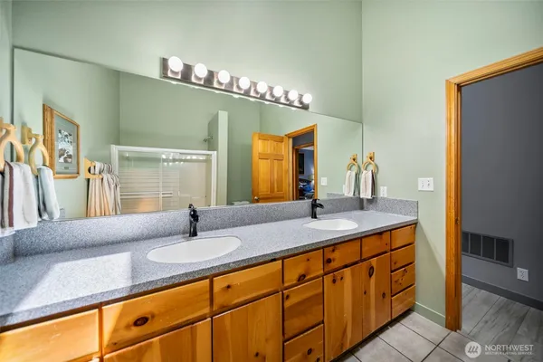 a bathroom with a sink double vanity and a mirror