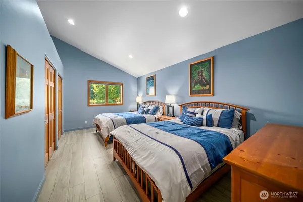 a bedroom with two beds and a window