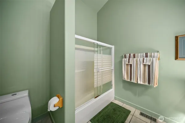 a bathroom with a window and a shower