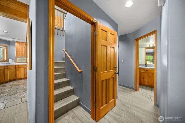 a view of a hallway with wooden floor and staircase