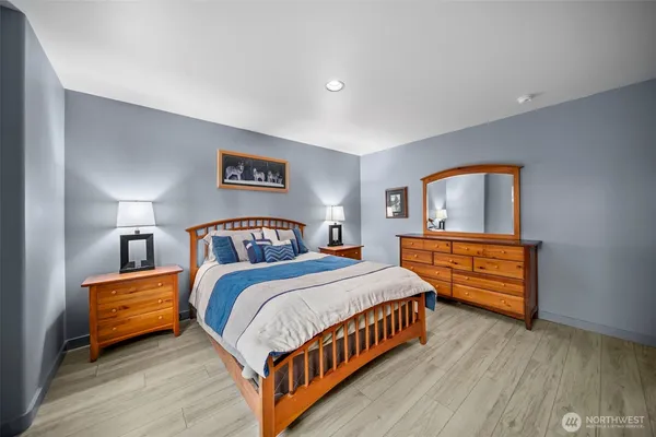 a bedroom with a bed and a tv on the dresser