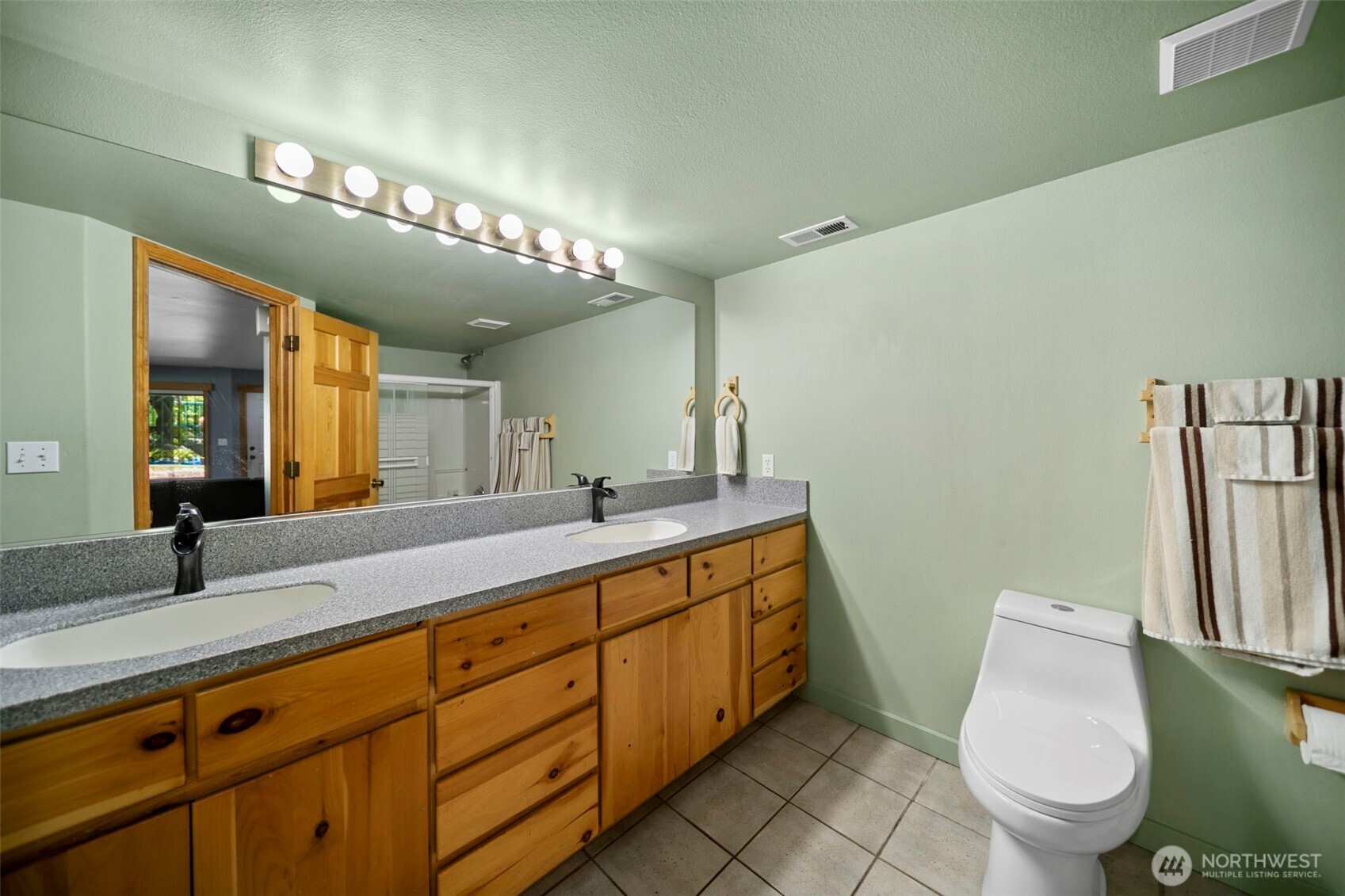 105 Chelan View Drive Manson, WA 98831 - Photo 29 of 40 a bathroom with a toilet sink and mirror