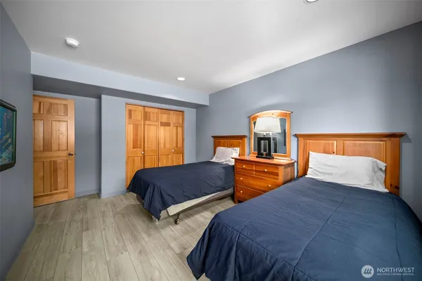 a bedroom with two beds and a dresser