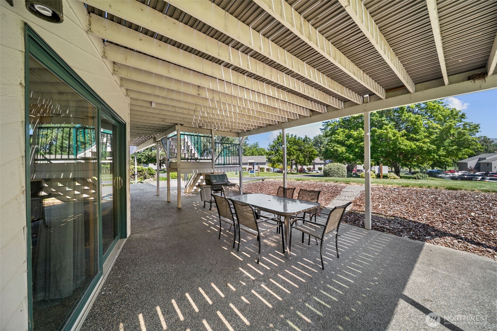 105 Chelan View Drive Manson, WA 98831 - Photo 34 of 40 a view of a patio with a table chairs and backyard