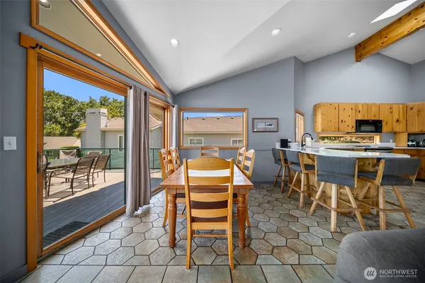 a dining room with furniture a rug and a painting