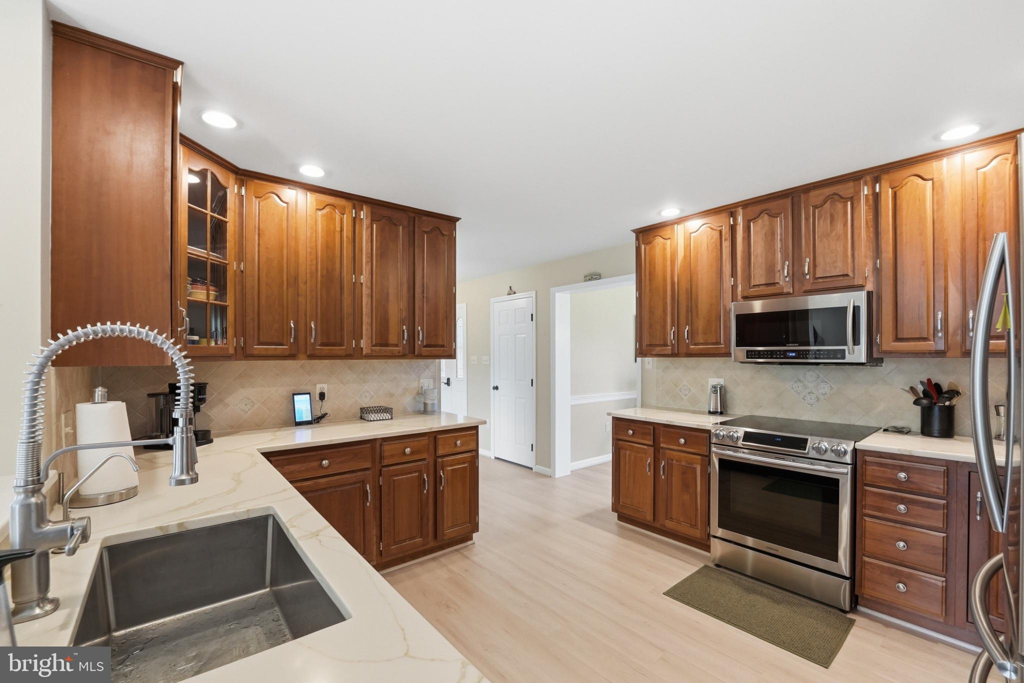 11337 Old Stillhouse Road Boston, VA 22713 - Photo 24 of 58 a kitchen with stainless steel appliances granite countertop wooden cabinets a stove top oven a sink and dishwasher