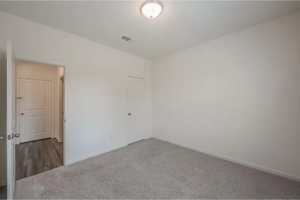 a bathroom with a bathtub shower sink vanity mirror and toilet