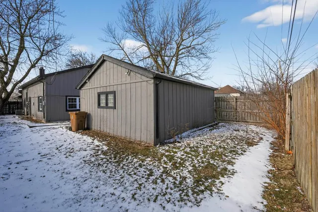 a view of a house with a yard covered in snow