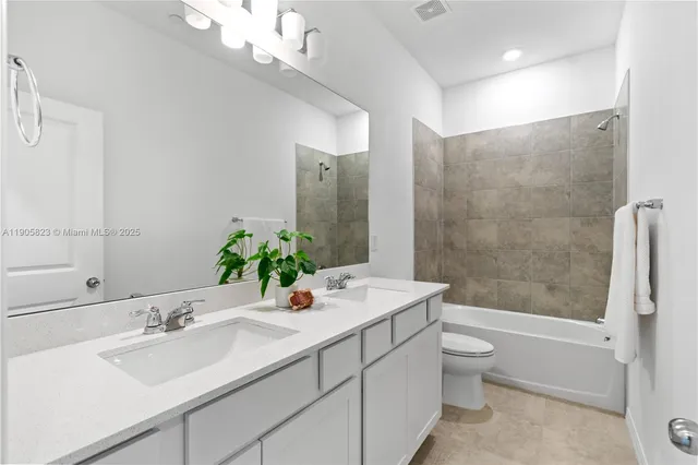 a kitchen that has a sink a stove and a wooden floor
