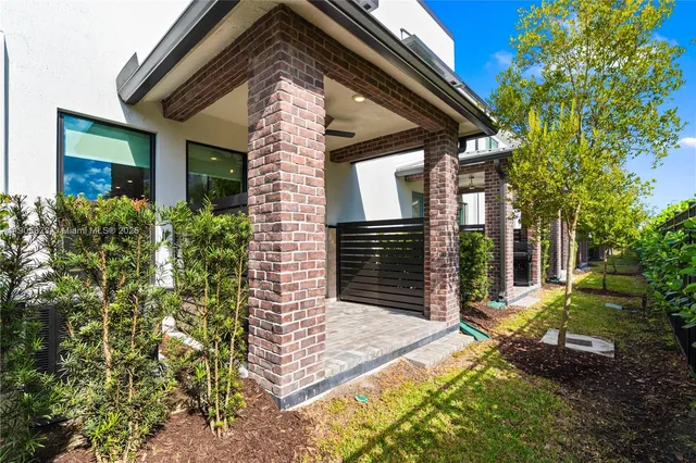 a view of a house with a small yard and plants