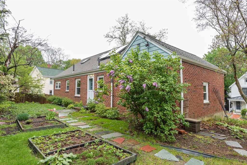 67 Smith Street Arlington, MA 02476 - Photo 28 of 32 a front view of a house with garden