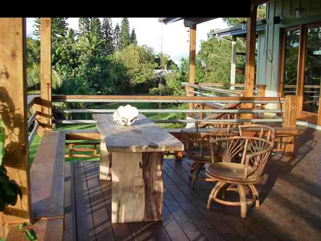 60 South Holokai Road Haiku, HI 96708 - Photo 7 of 30 a view of a patio with table and chairs with wooden floor and fence