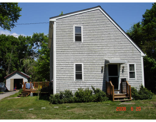 18 Old Bridge Road Bourne, MA 02532 - Photo 2 of 14 a front view of a house with a yard and trees