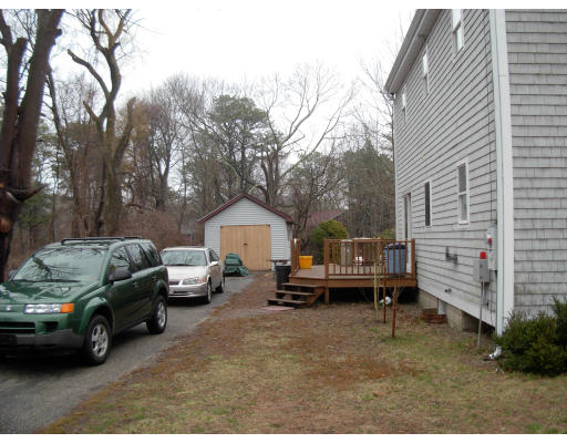 18 Old Bridge Road Bourne, MA 02532 - Photo 5 of 14 a view of a house with a cars park side of a road