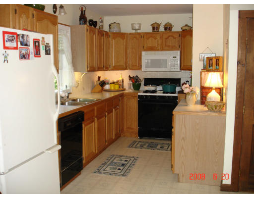 18 Old Bridge Road Bourne, MA 02532 - Photo 10 of 14 a kitchen with a refrigerator and a stove