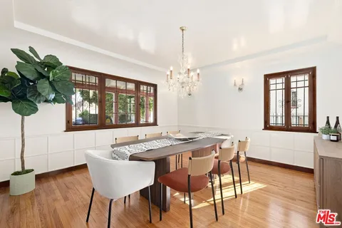 a view of a dining room with furniture window and wooden floor