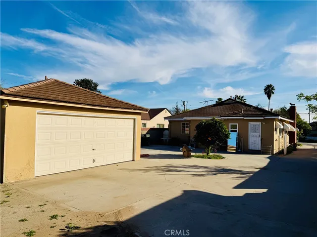a kitchen with white cabinets sink and stove