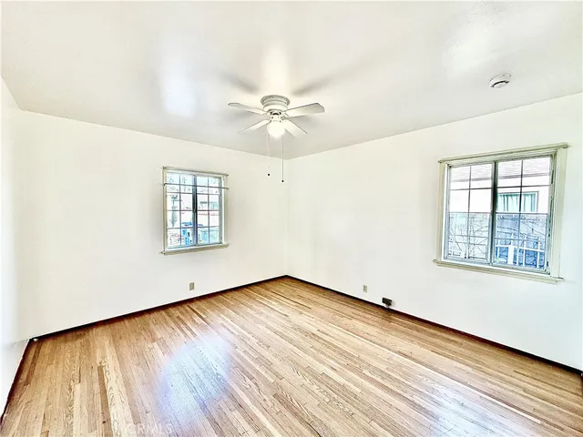 a view of an empty room with a fireplace and a window