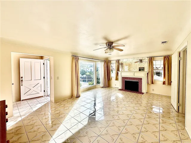 a view of an empty room with a fireplace