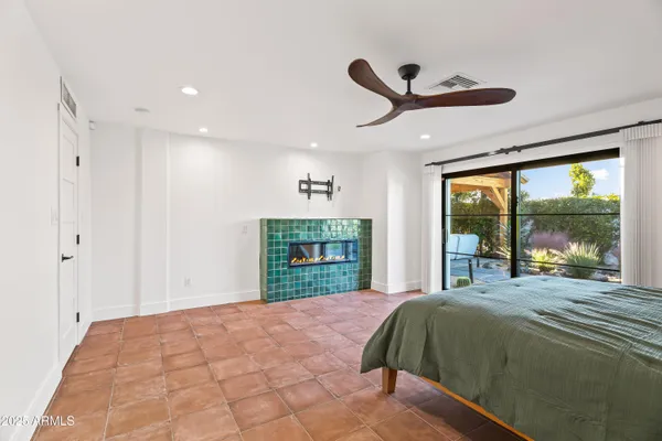 a bedroom with a bed and a large window