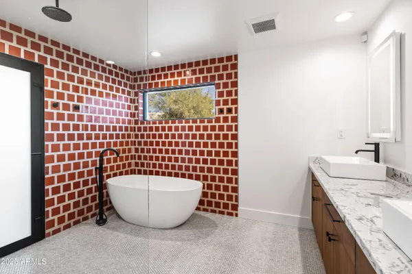 a bathroom with a sink a toilet and mirror