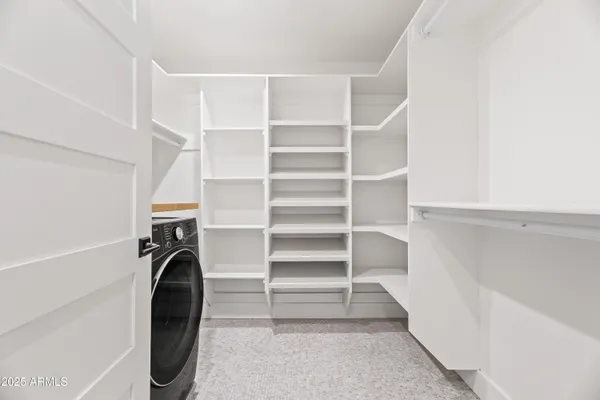 a view of walk in closet with empty racks