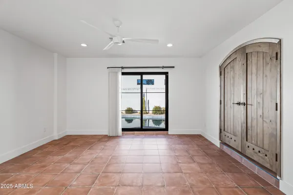 a view of an empty room with window and cabinet