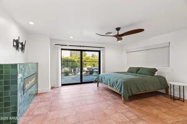 a living room with a bed furniture and a large window