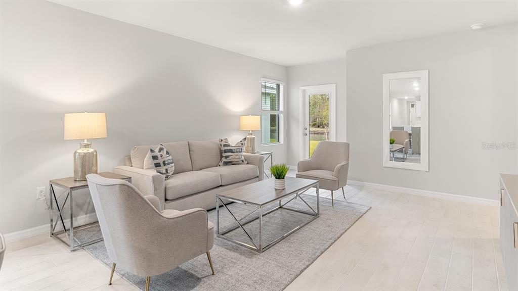 2994 Northeast 21st Ct Road Ocala, FL 34479 - Photo 4 of 9 a living room with furniture and a lamp