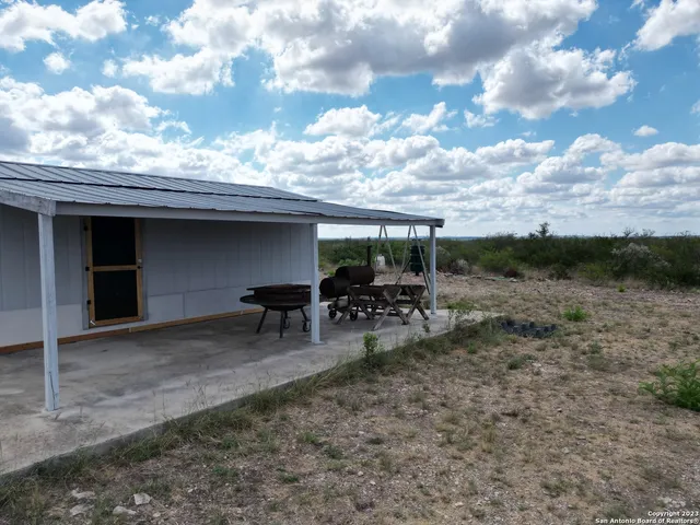 a view of house with yard barbeque oven and outdoor seating