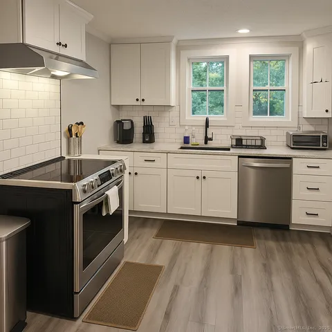 a kitchen with a stove a sink and a window