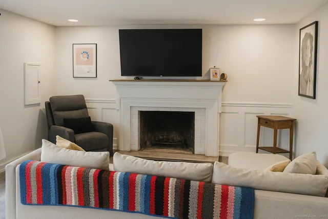 a living room with furniture fireplace and flat screen tv