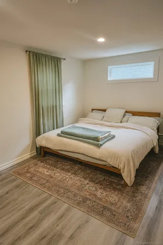 a bedroom with a bed and a window