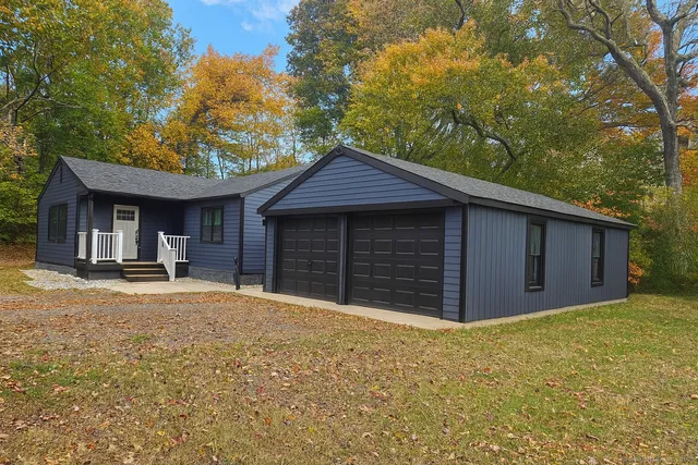 a front view of a house with a yard and garage