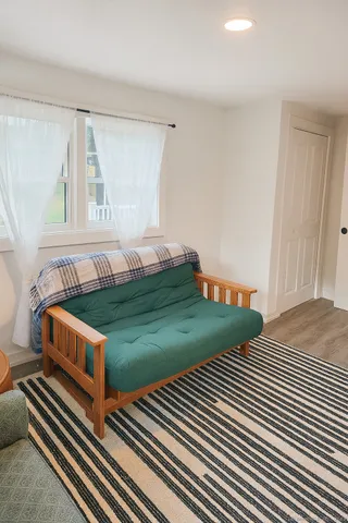 a bedroom with two beds and a baby crib