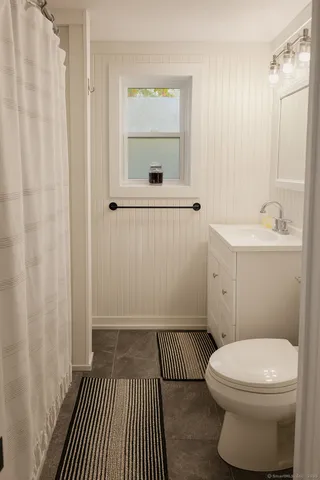 a bathroom with a sink a toilet and a shower