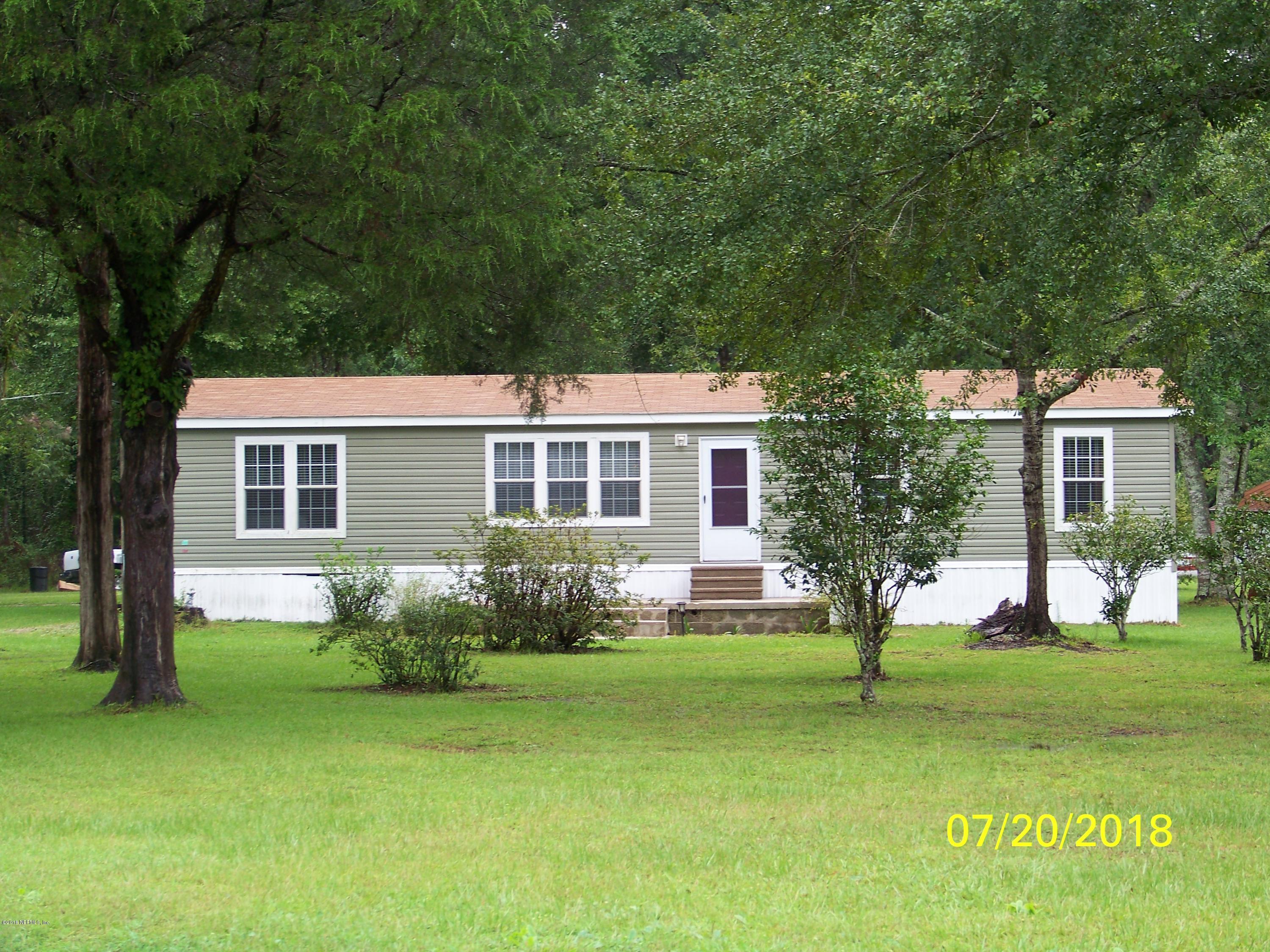 54314 Lawhon Road West Callahan, FL 32011 - Photo 1 of 30 a front view of a house with garden