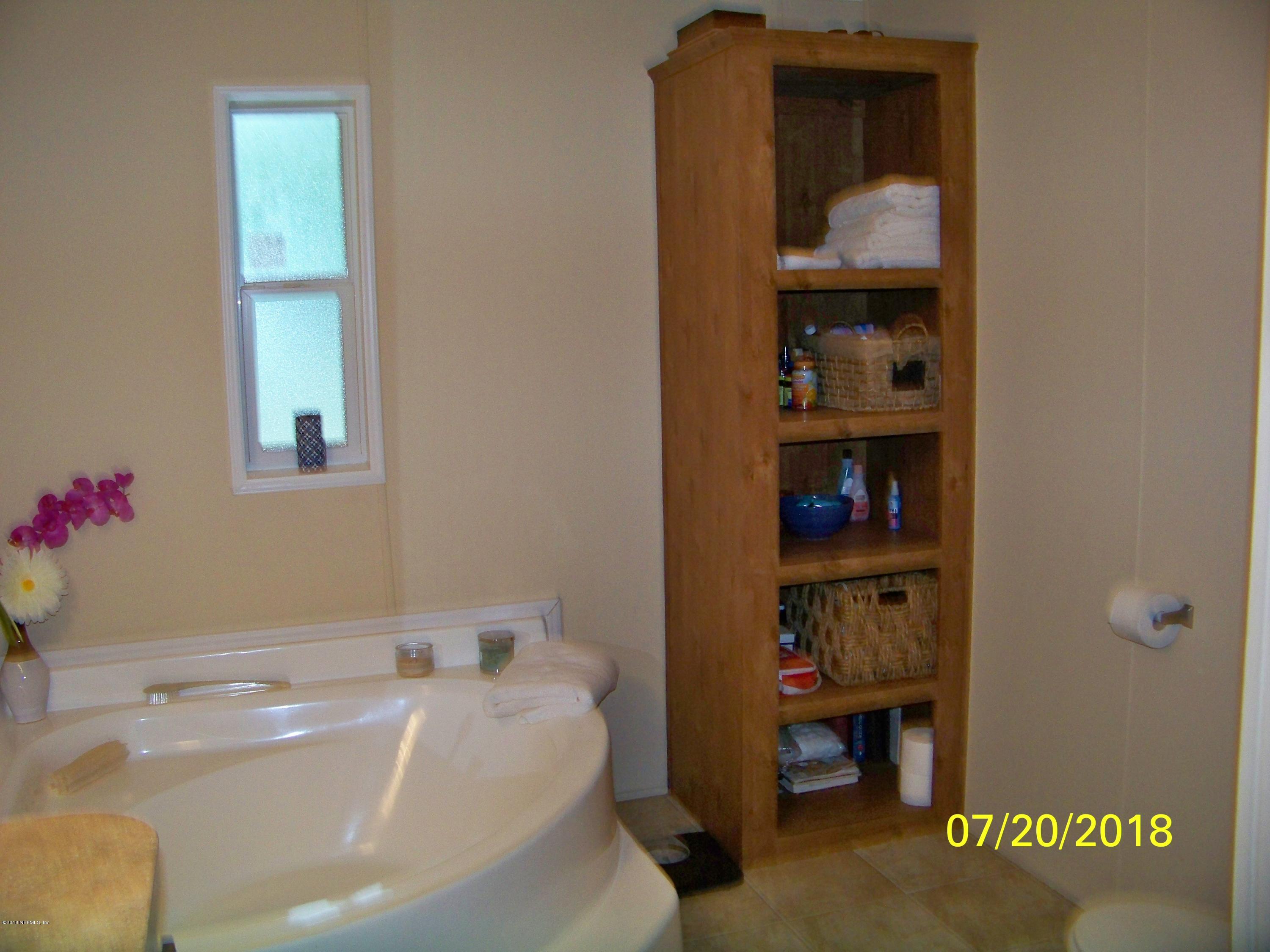 54314 Lawhon Road West Callahan, FL 32011 - Photo 11 of 30 a bathroom with a bathtub sink and vanity