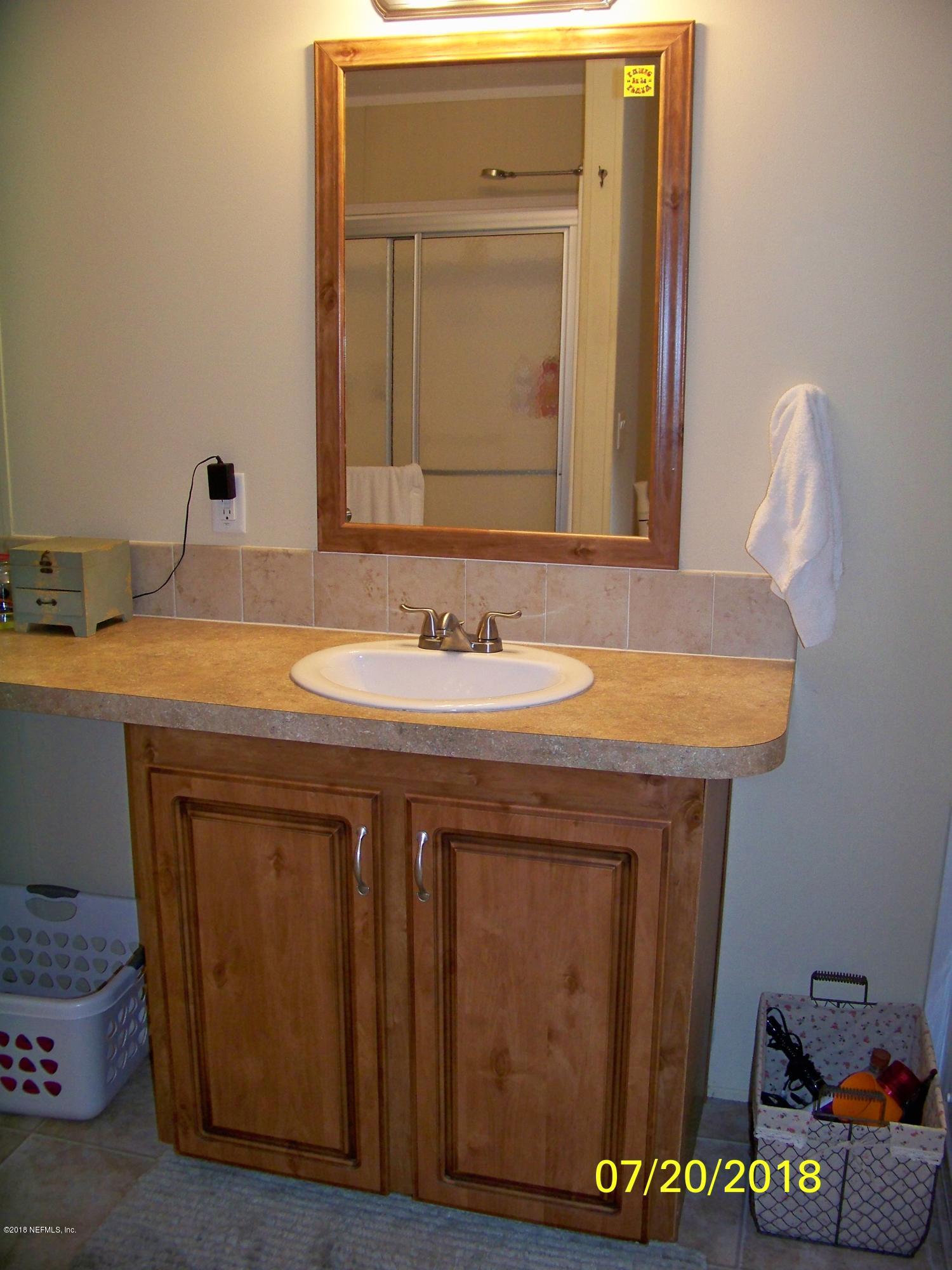 54314 Lawhon Road West Callahan, FL 32011 - Photo 12 of 30 a bathroom with a sink and a mirror