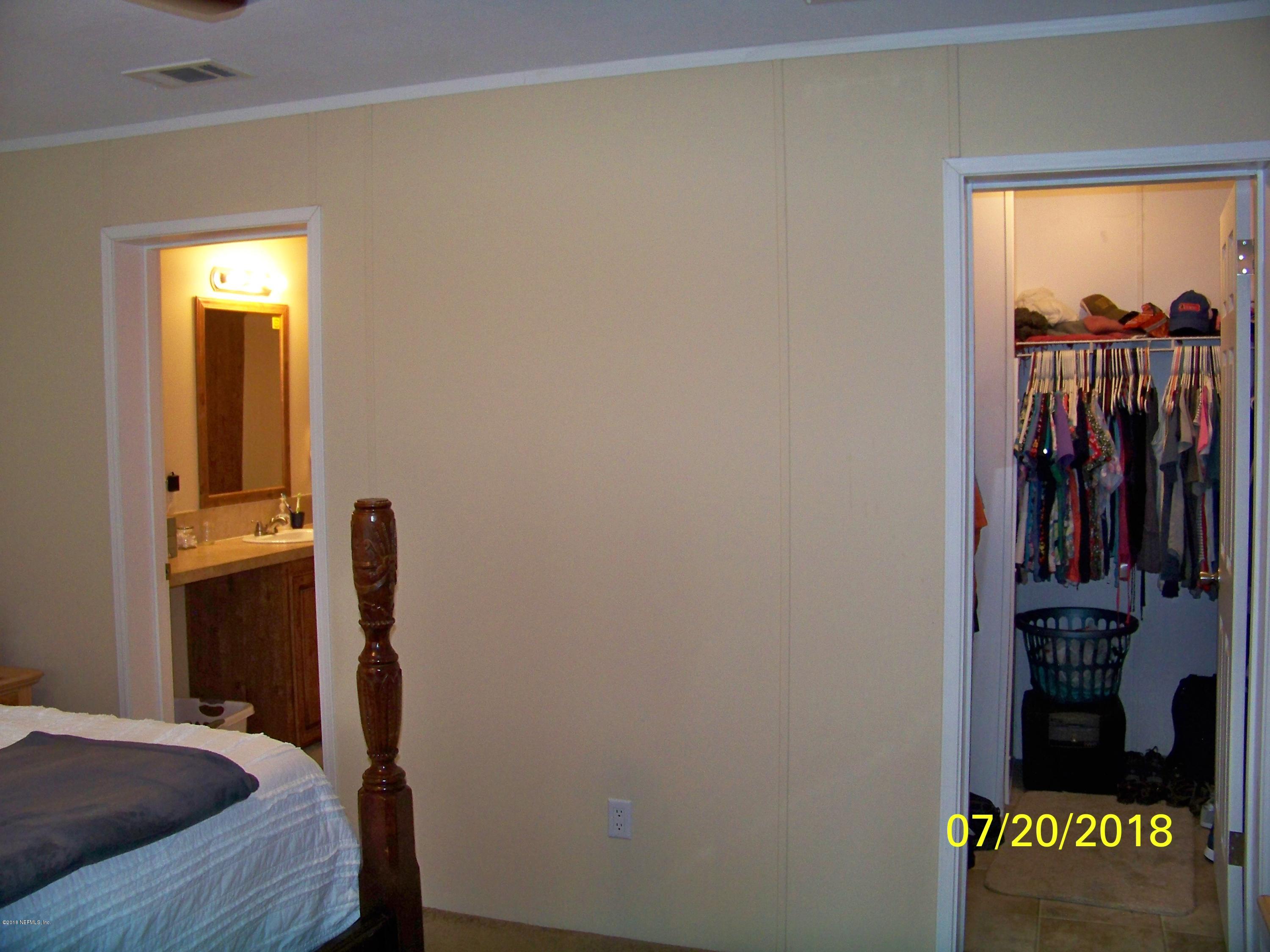 54314 Lawhon Road West Callahan, FL 32011 - Photo 14 of 30 a view of walk in closet with clothes and shoes