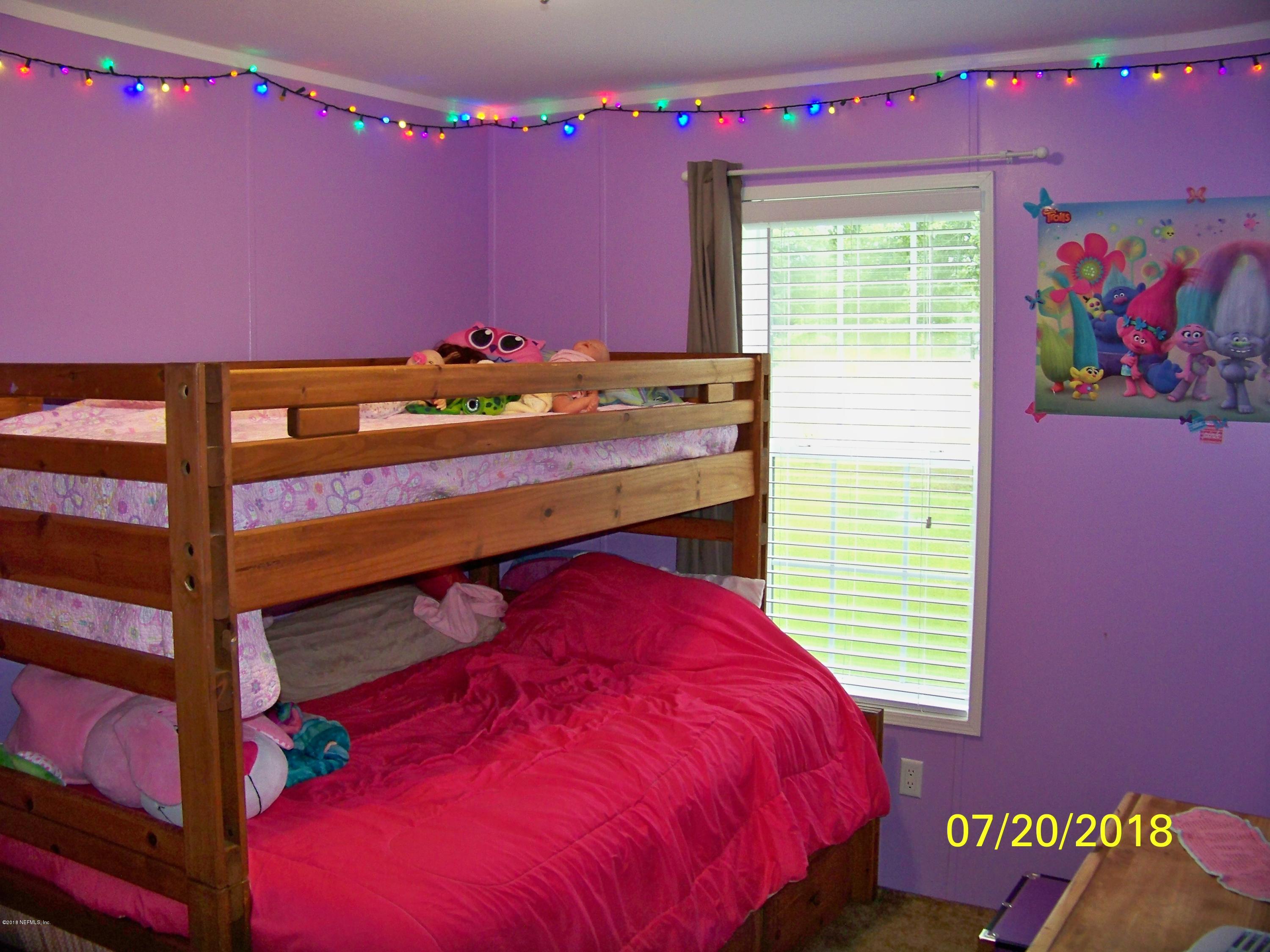 54314 Lawhon Road West Callahan, FL 32011 - Photo 18 of 30 a bed room with a bed and a window