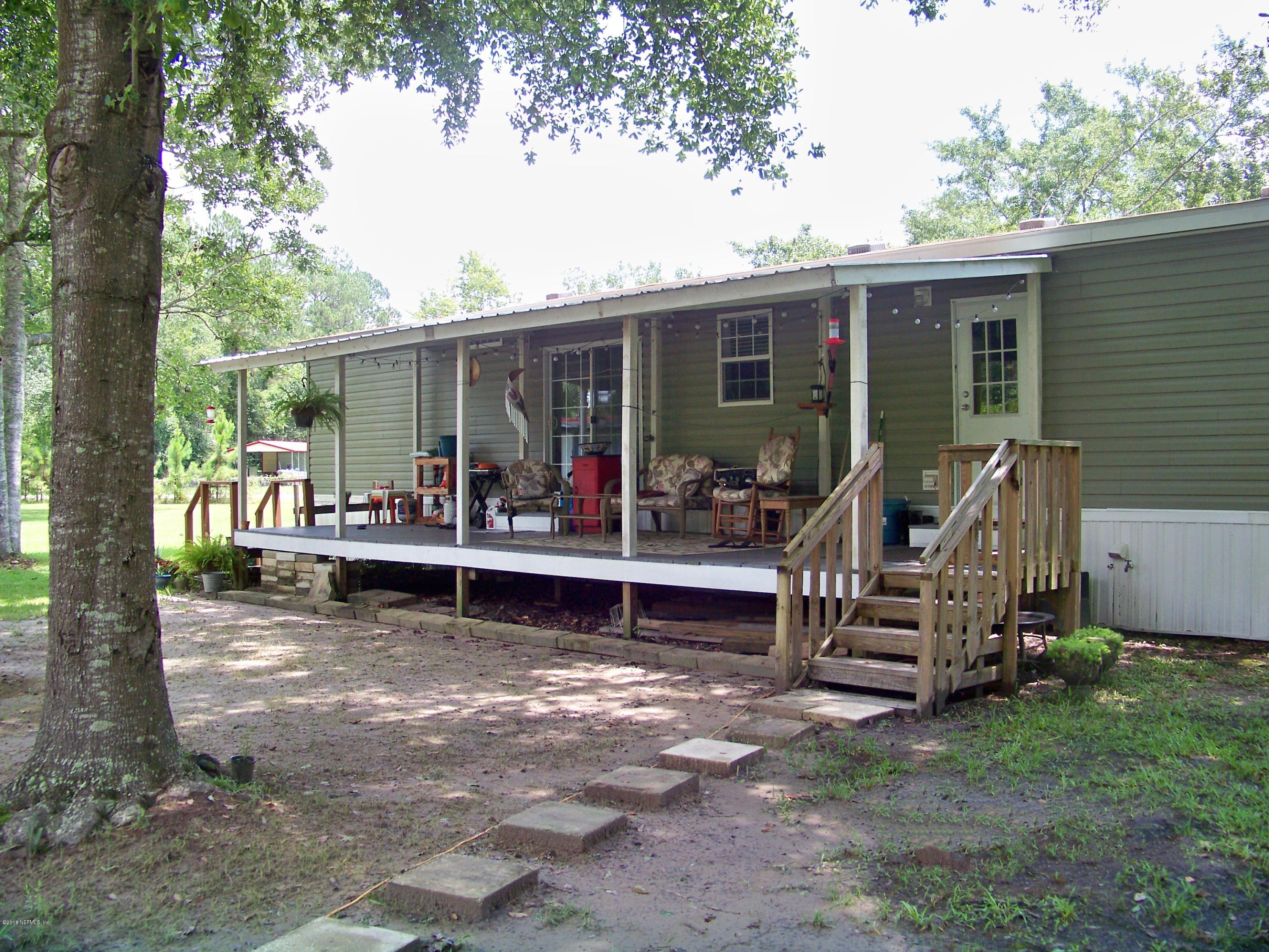 54314 Lawhon Road West Callahan, FL 32011 - Photo 27 of 30 a view of a house with backyard sitting area and garden