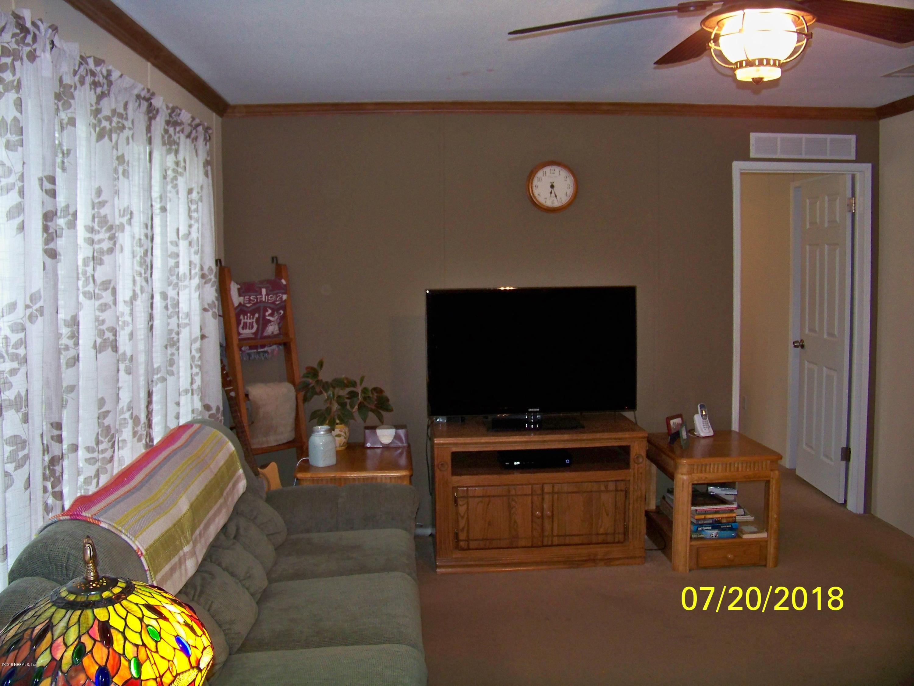 54314 Lawhon Road West Callahan, FL 32011 - Photo 3 of 30 a living room with furniture and a flat screen tv